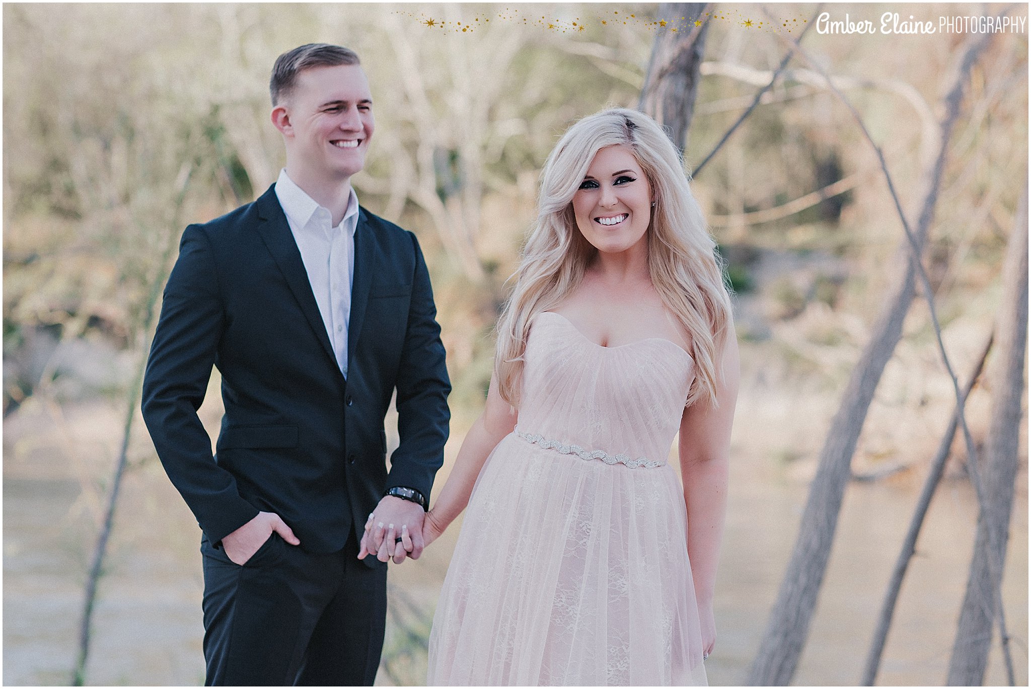 film look couple wearing maxi lace blush dress and fitted black suit